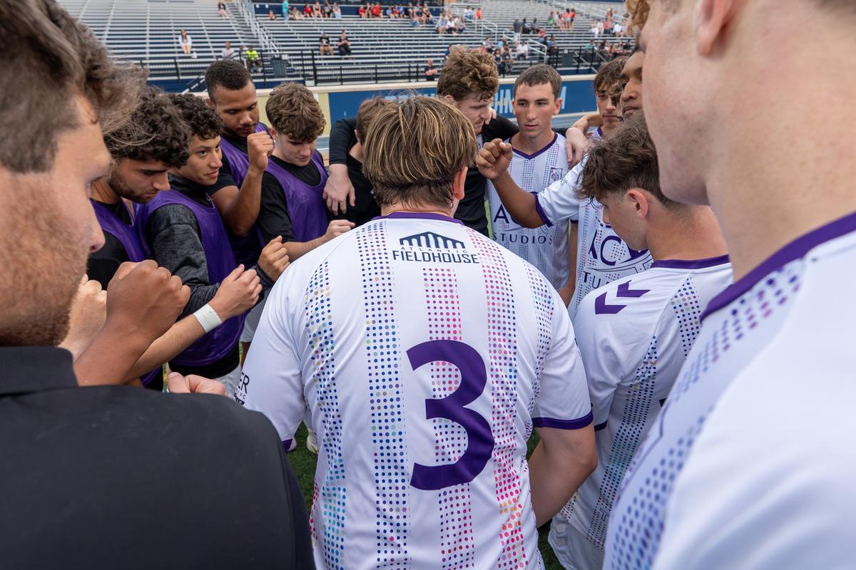 The Atlantic City FC squad in a huddle before kickoff